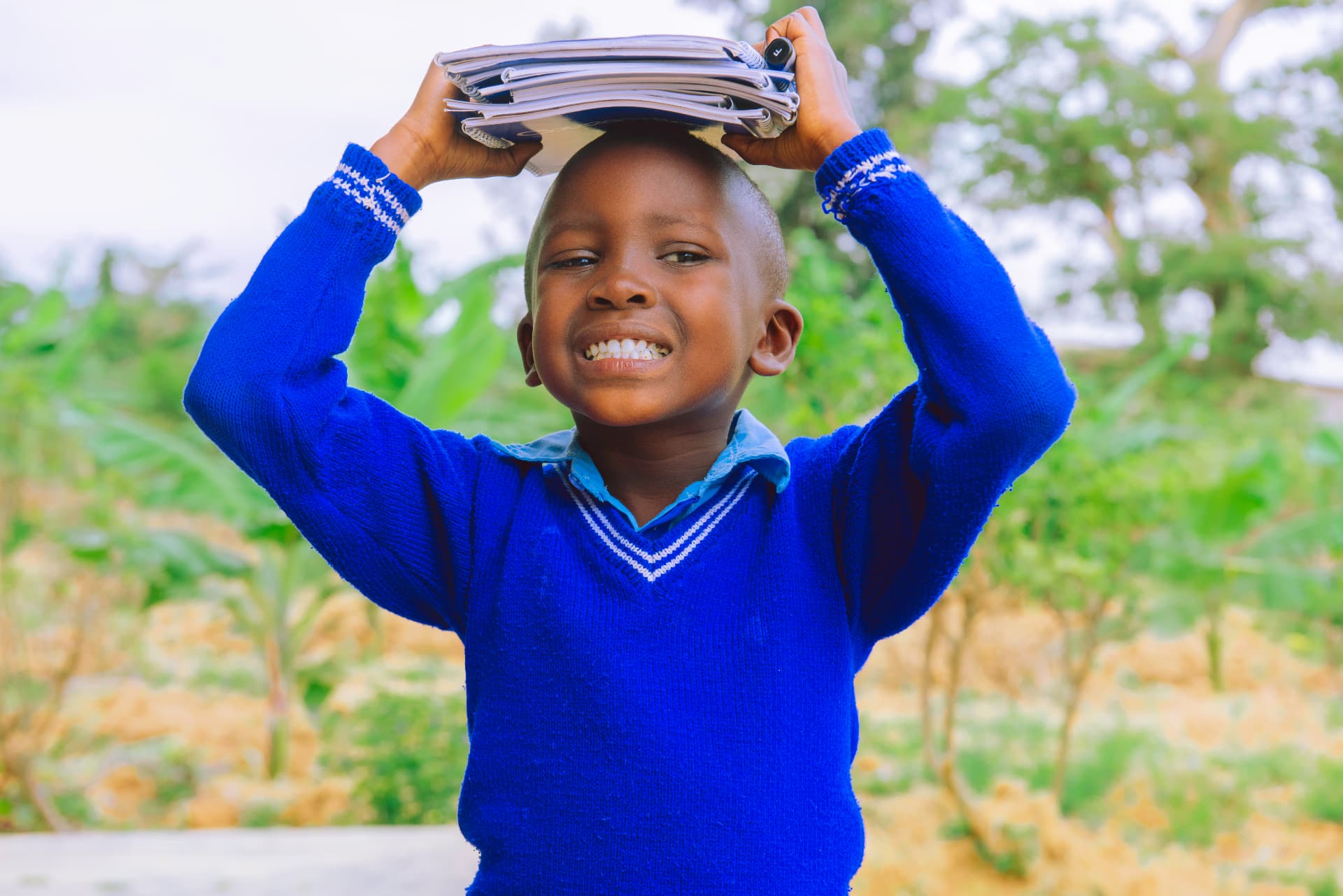 Student holding a stack of Correctbook notebooks